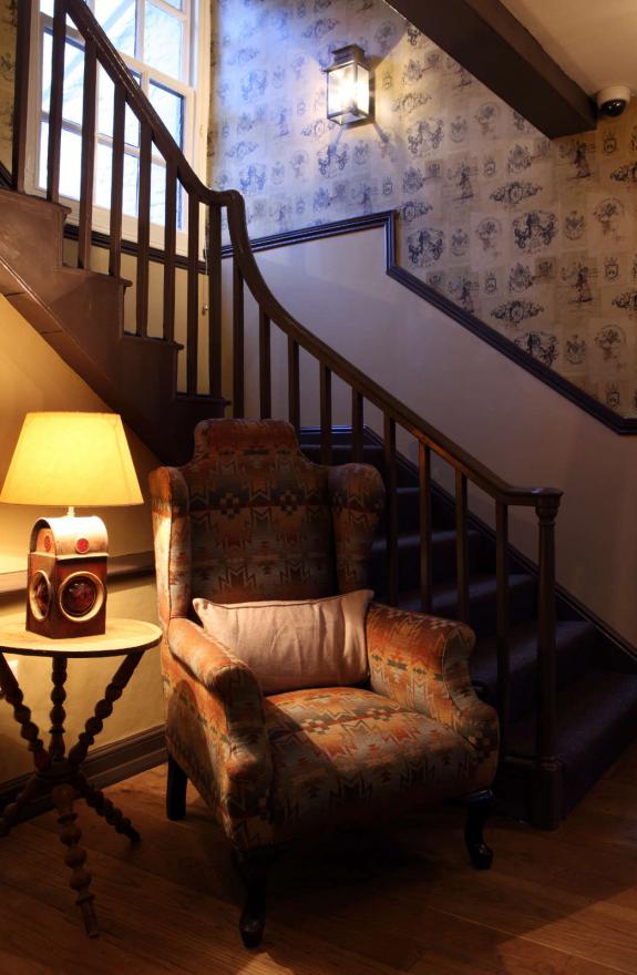 Entrance hall chair with lamp by stairs